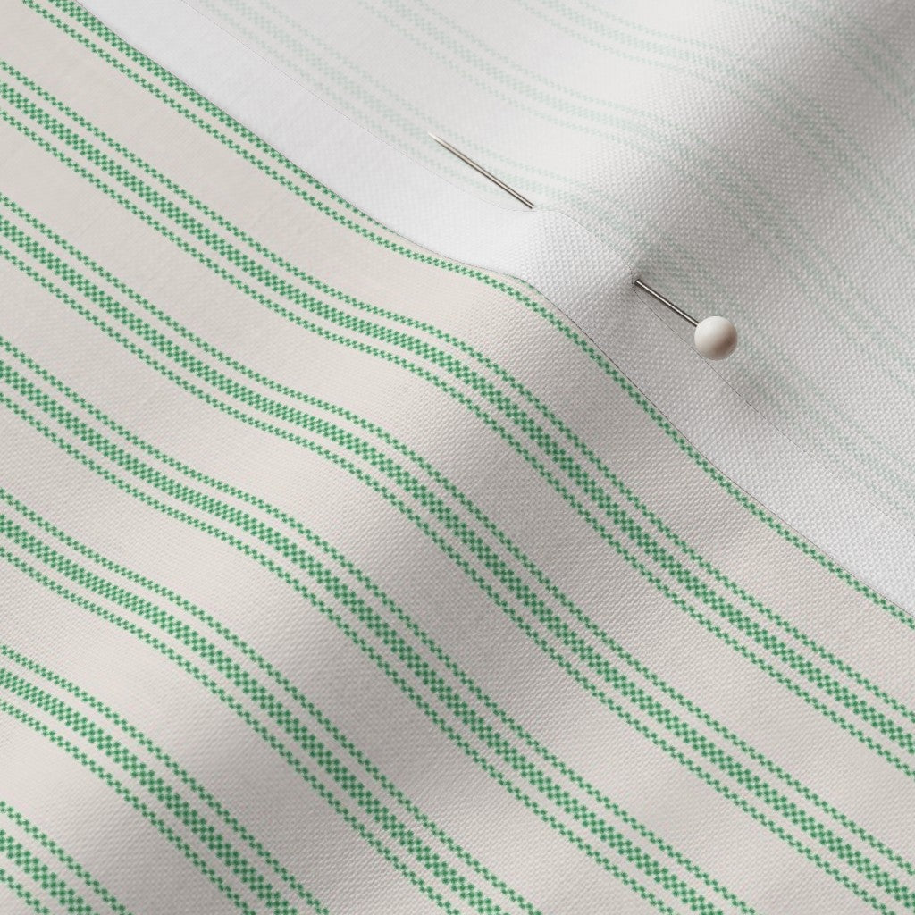 close up of mattress ticking stripe fabric in kelly green on off white