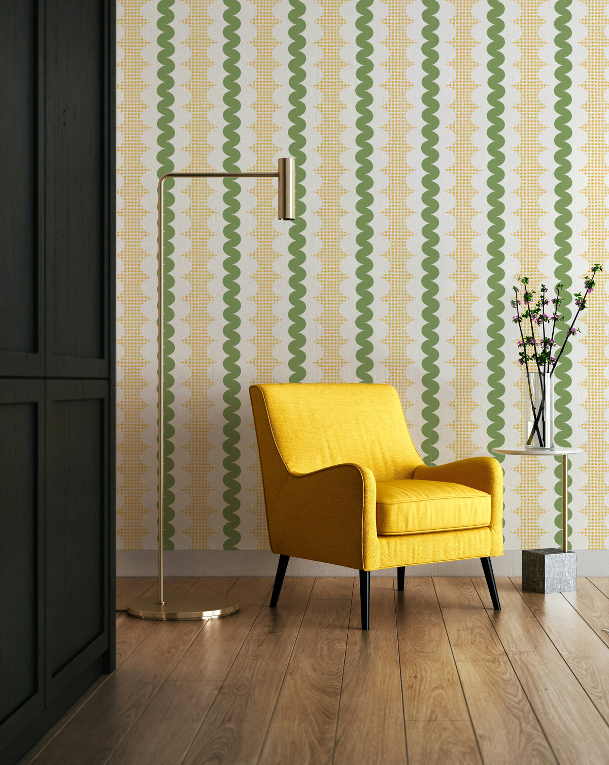 A styled interior scene featuring a bright yellow armchair in front of a wall with repeating vertical wavy stripes in green and cream. A tall brass floor lamp stands to the left, and a small side table with a vase of branches sits to the right.