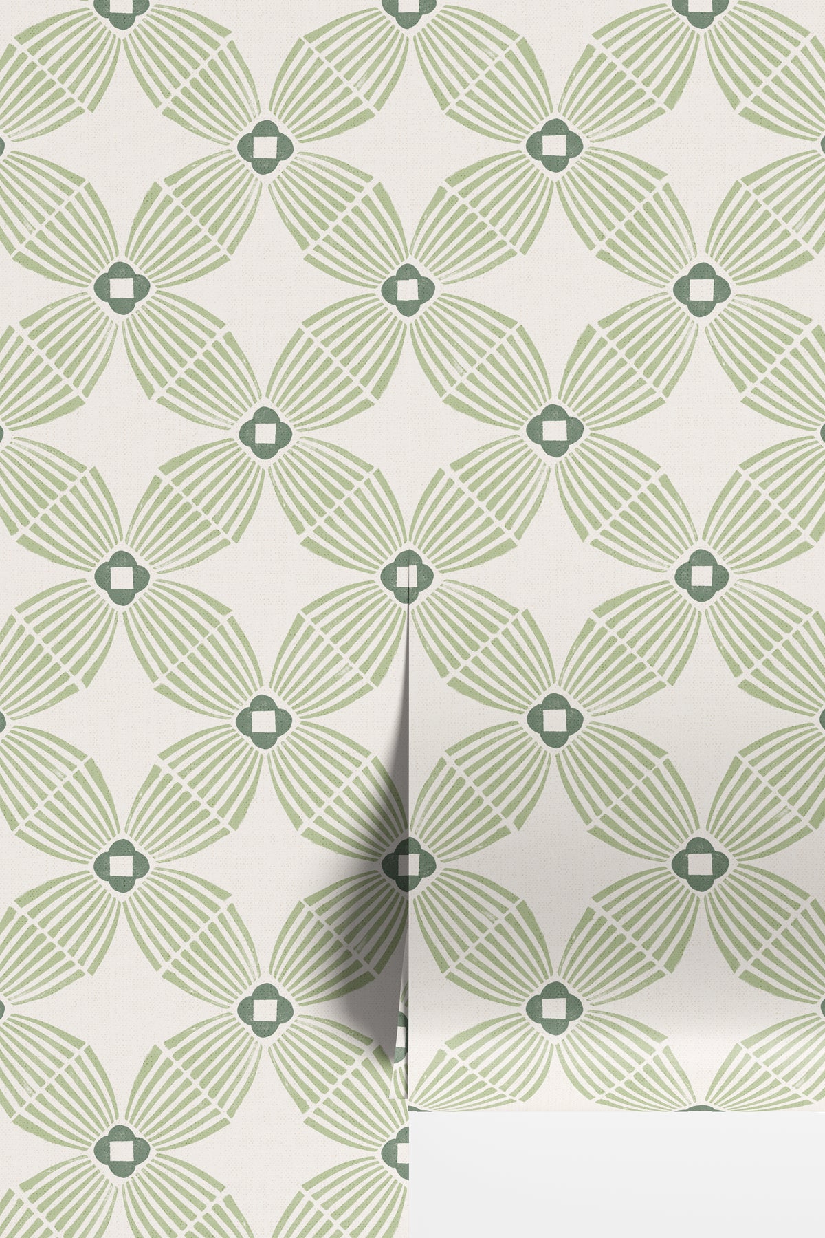 A close-up of wallpaper with a repeating geometric floral pattern in sage green and gray on an off-white background, with a folded corner showing the reverse side.