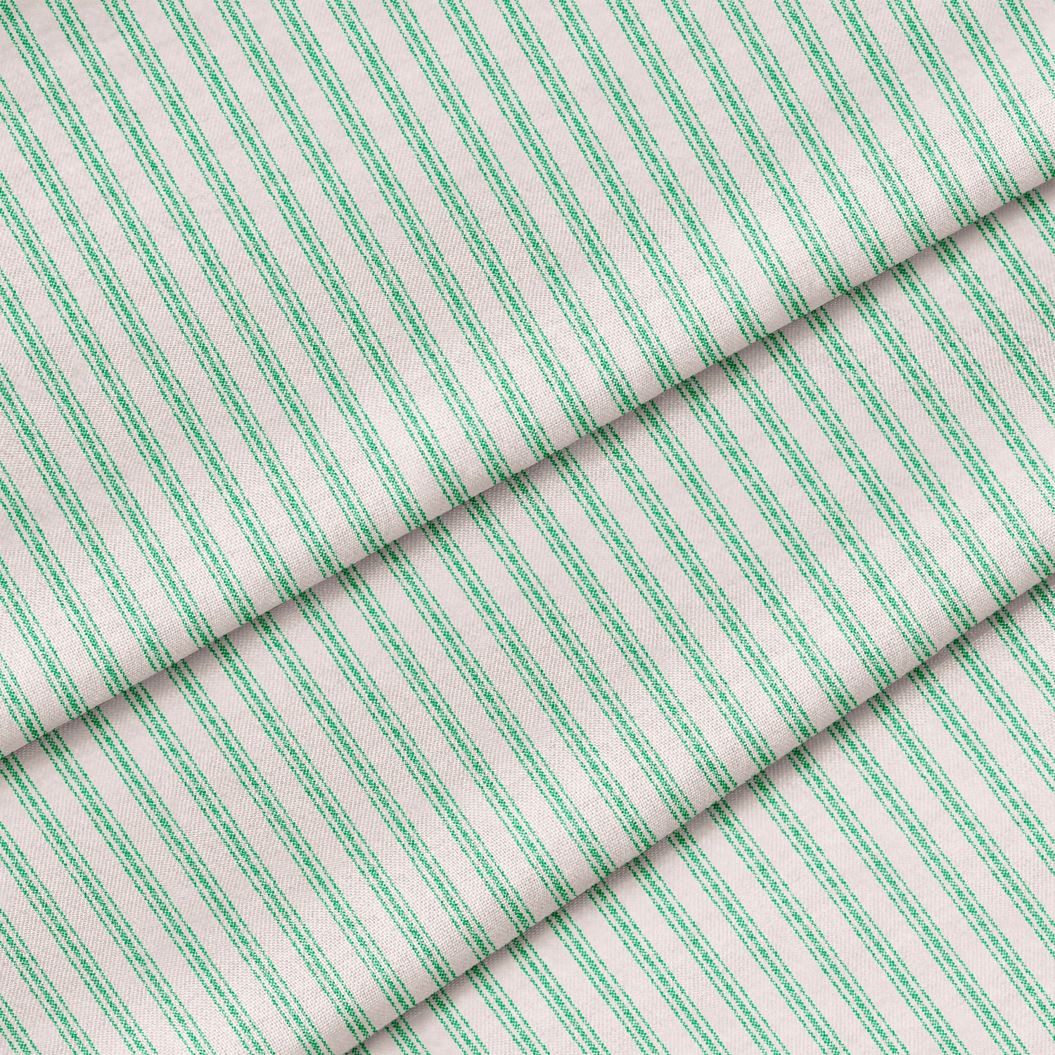 Close-up of a kelly green ticking stripe fabric. The fabric is folded onto itself.