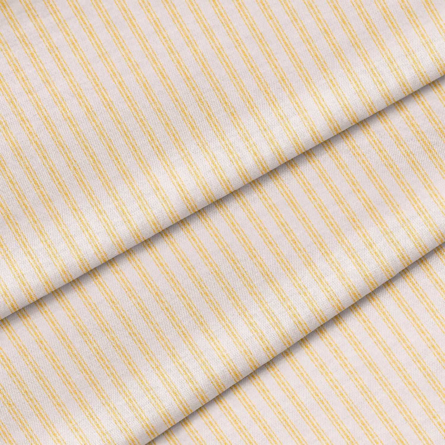 Close up of a yellow mattress ticking stripe. The fabric is folded onto itself.