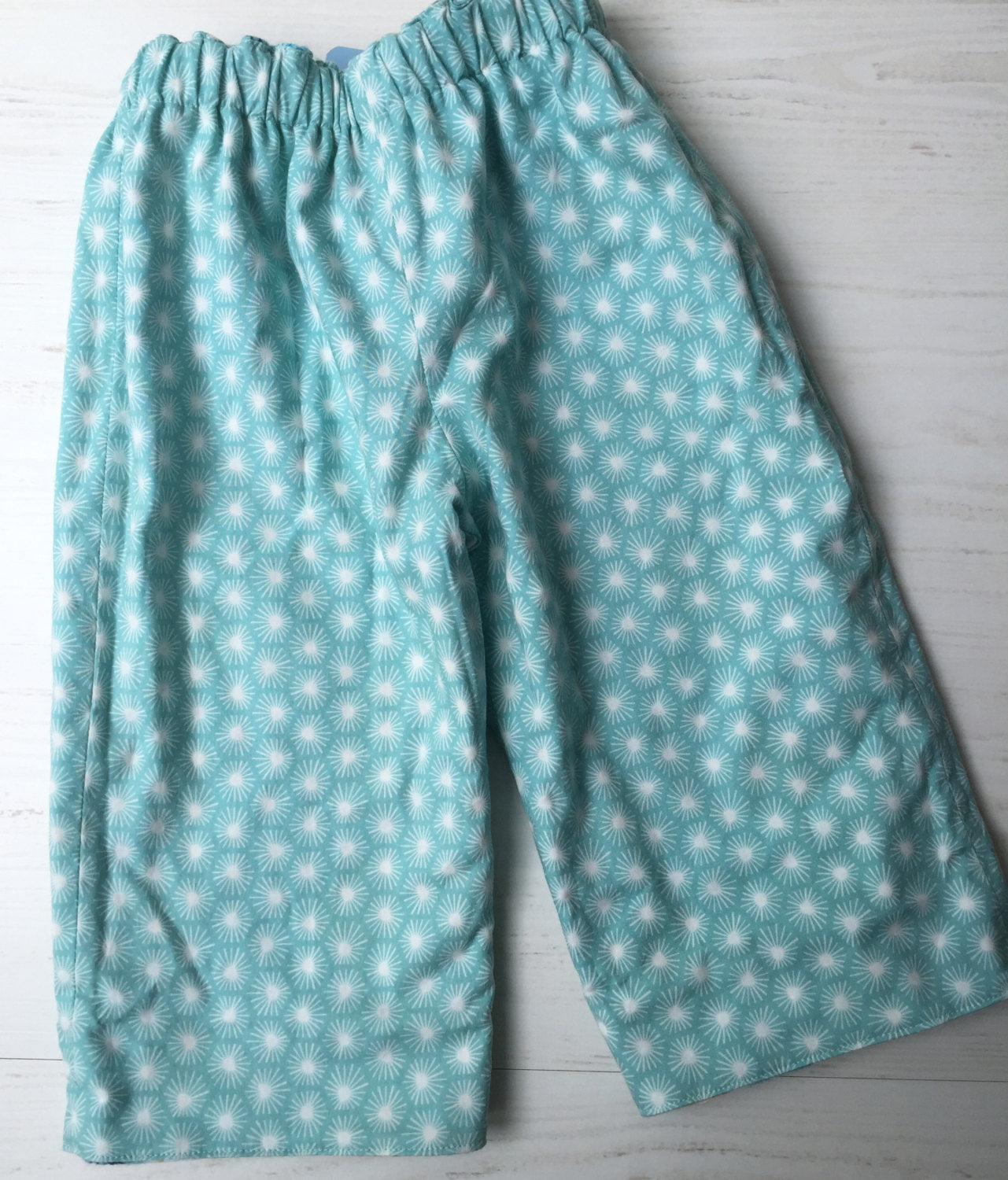 flannel reversible pants in park tree - little girl Pearl