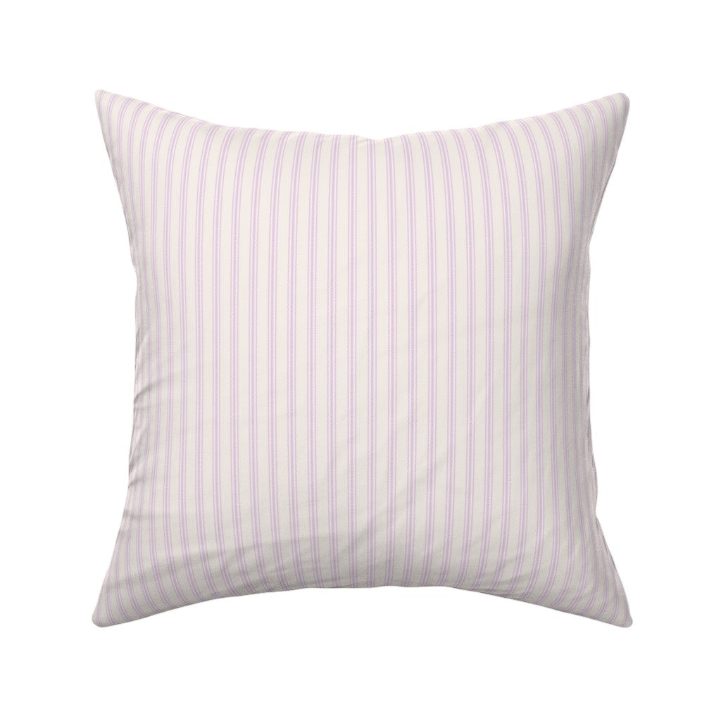 Classic mattress ticking stripe fabric shown on a square pillow. The color of the stripe is lilac pastel on off white.