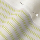 close up of mattress ticking stripe fabric in lime green on off white