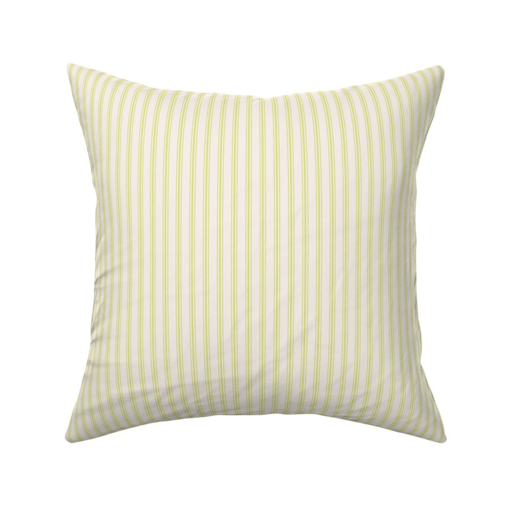 Classic mattress ticking stripe fabric shown on a square pillow. The color of the stripe is lime green on off white.