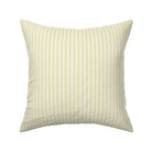 Classic mattress ticking stripe fabric shown on a square pillow. The color of the stripe is lime green on off white.