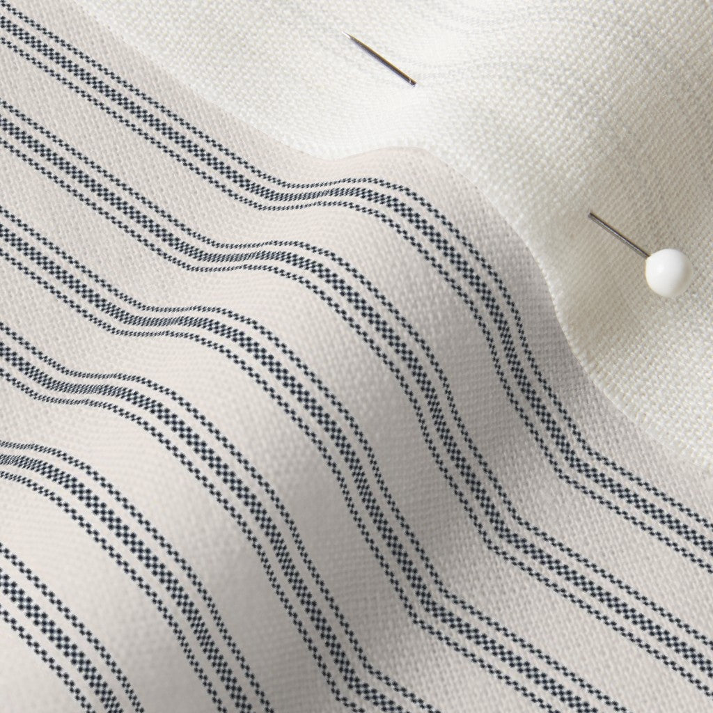 close up of mattress ticking stripe fabric in navy blue on off white