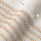 close up of mattress ticking stripe fabric in orange tangerine on off white