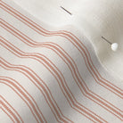 close up of mattress ticking stripe fabric in farmhouse red on off white