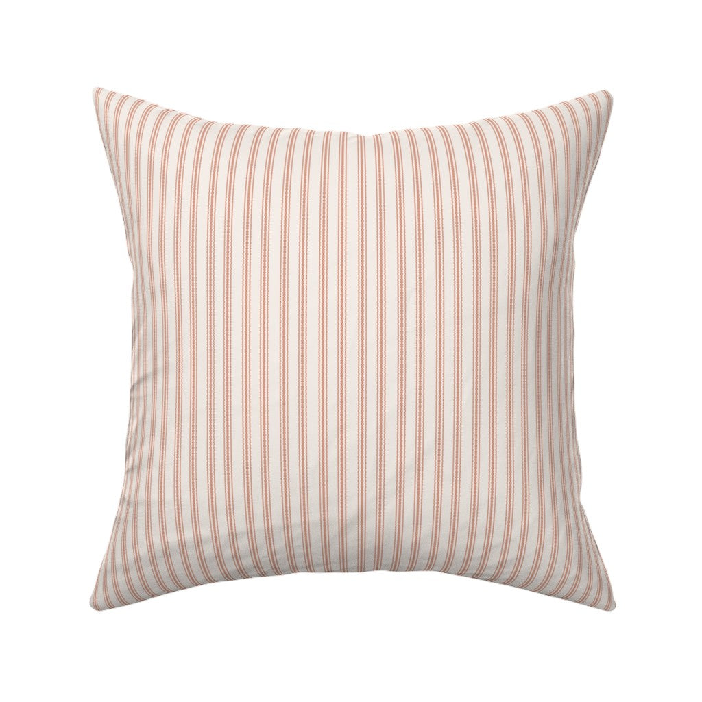Classic mattress ticking stripe fabric shown on a square pillow. The color of the stripe is farmhouse red on off white.