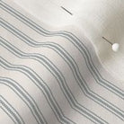 close up of mattress ticking stripe fabric in stormy gray on off white