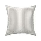 Classic mattress ticking stripe fabric shown on a square pillow. The color of the stripe is stormy gray on off white.