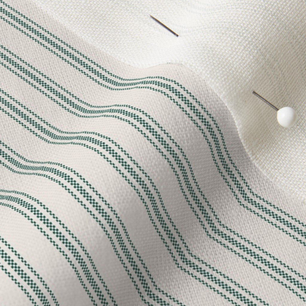 close up of mattress ticking stripe fabric in british racing green on off white