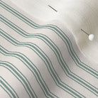 close up of mattress ticking stripe fabric in british racing green on off white
