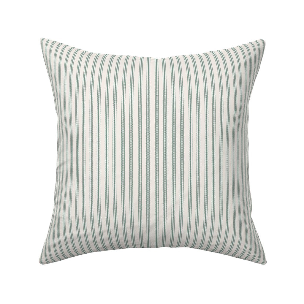 Classic mattress ticking stripe fabric shown on a square pillow. The color of the stripe is british racing green on off white.