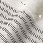 close up of mattress ticking stripe fabric in charcoal black on off white