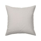 Classic mattress ticking stripe fabric shown on a square pillow. The color of the stripe is charcoal black on off white.