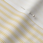 close up of mattress ticking stripe fabric in sunny yellow on off white