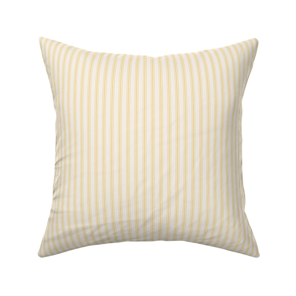 Classic mattress ticking stripe fabric shown on a square pillow. The color of the stripe is yellow on off white.