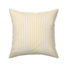 Classic mattress ticking stripe fabric shown on a square pillow. The color of the stripe is yellow on off white.