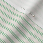 close up of mattress ticking stripe fabric in kelly green on off white