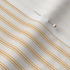 close up of classic mattress ticking stripe fabric in saffron marigold on cream white