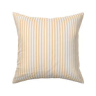 Classic mattress ticking stripe fabric shown on a square pillow. The color of the stripe is saffron on off white.
