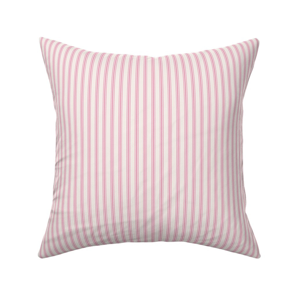 Classic mattress ticking stripe fabric shown on a square pillow. The color of the stripe is hot pink on off white.