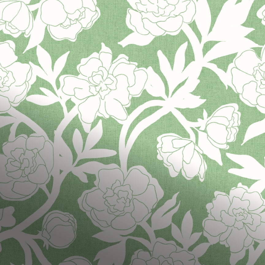 A close-up of a floral patterned fabric or wallpaper featuring white peony-like flowers and leaves on a muted sage green background.