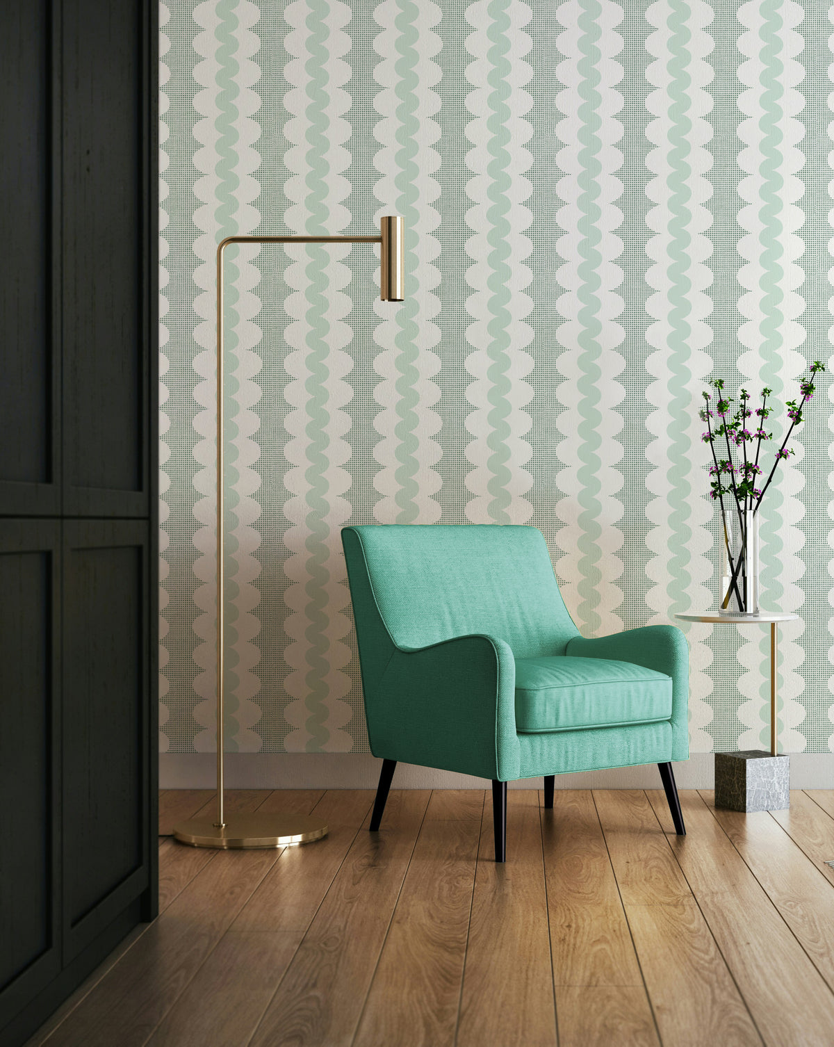 A modern mint green armchair with black legs sits in a styled room with a patterned grandmilennial striped wallpaper background, a brass floor lamp, and a small side table with a vase.