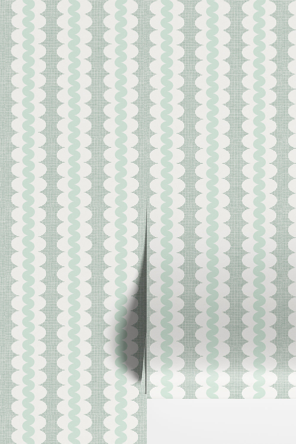 A close-up of wallpaper with a repeating vertical pattern of pale mint green and white wavy scallop shapes over a subtle light gray grid, with a folded corner showing a white surface underneath.