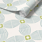 A roll of wallpaper with a repeating geometric pattern in light blue and olive green on an off-white background, shown partially unrolled.
