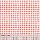 Gingham plaid patterned fabric in orange and pink and off white. There is an inch scale overlaid at the bottom for visual reference.