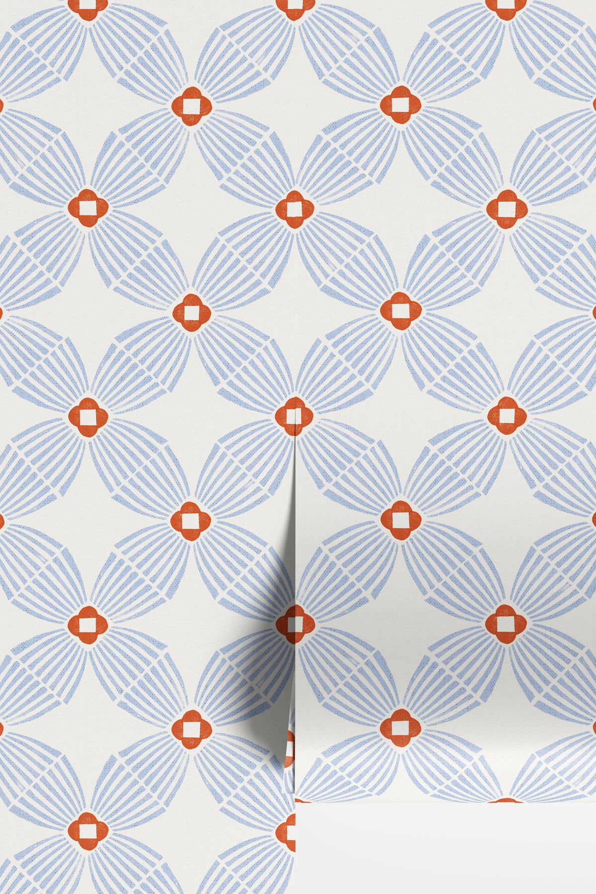 A close-up of wallpaper rolls with a repeating geometric floral pattern in light  blue and blaze orange on an off-white background.