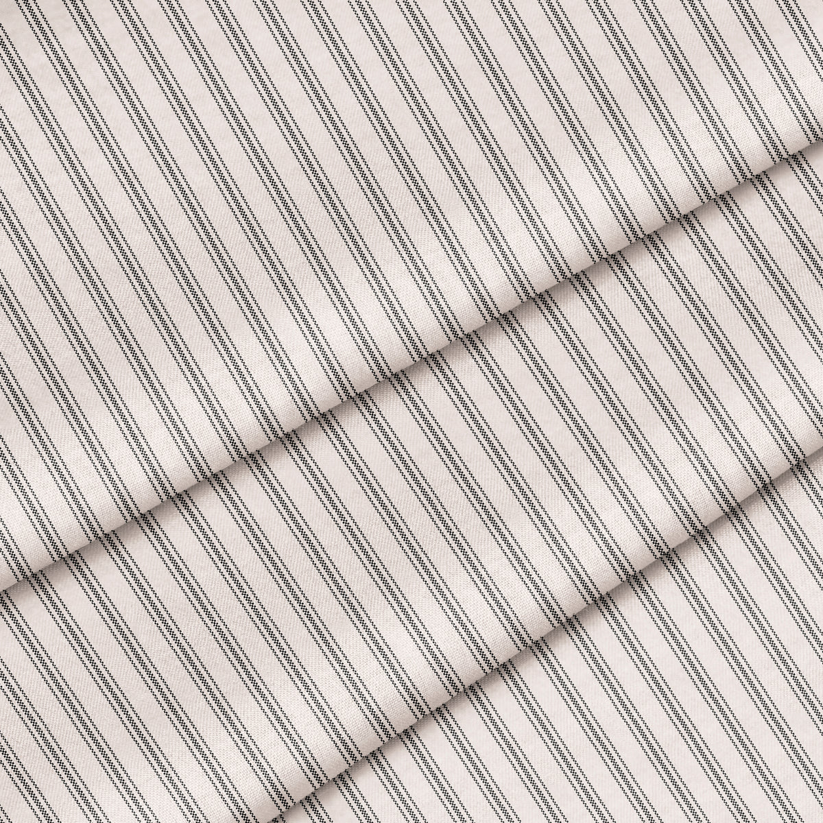 Close-up of a charcoal black and white ticking stripe fabric. The fabric is folded onto itself.