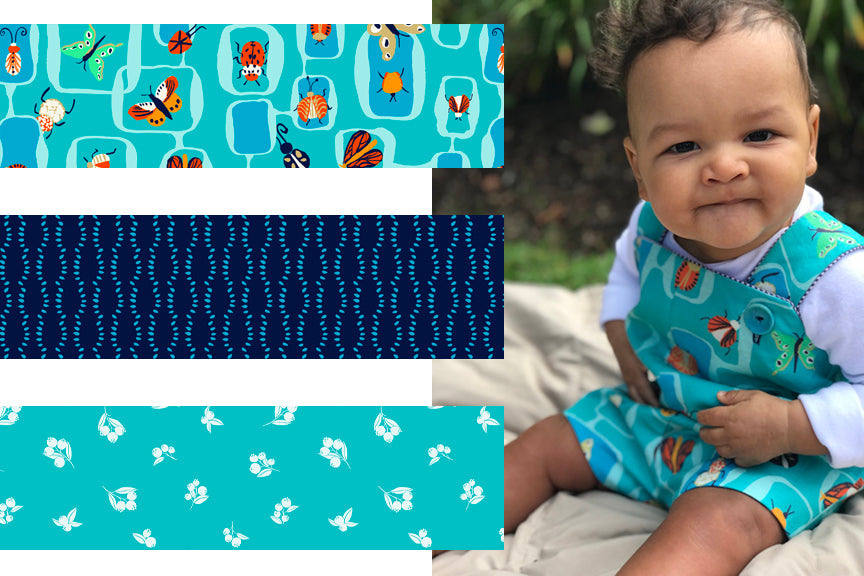 Adorable baby boy wearing handmade overalls featuring a cute teal blue bug print with three supporting and coordinating prints by Melissa McKeagney of buue studio