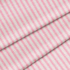 Yard of classic ticking stripe fabric featuring hot pink and white stripes. The fabric is folded onto itself.