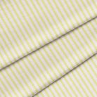 A close-up of a lime green fabric with a classic ticking stripe pattern. The fabric is folded onto itself.