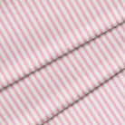 A magenta and white striped fabric with a classic ticking pattern. The fabric is folded onto itself.