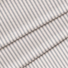 A close-up of navy blue striped fabric with a classic ticking pattern. The fabric is folded onto itself.