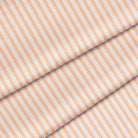 A close-up image of an orange and white striped ticking fabric. The fabric is folded onto itself.