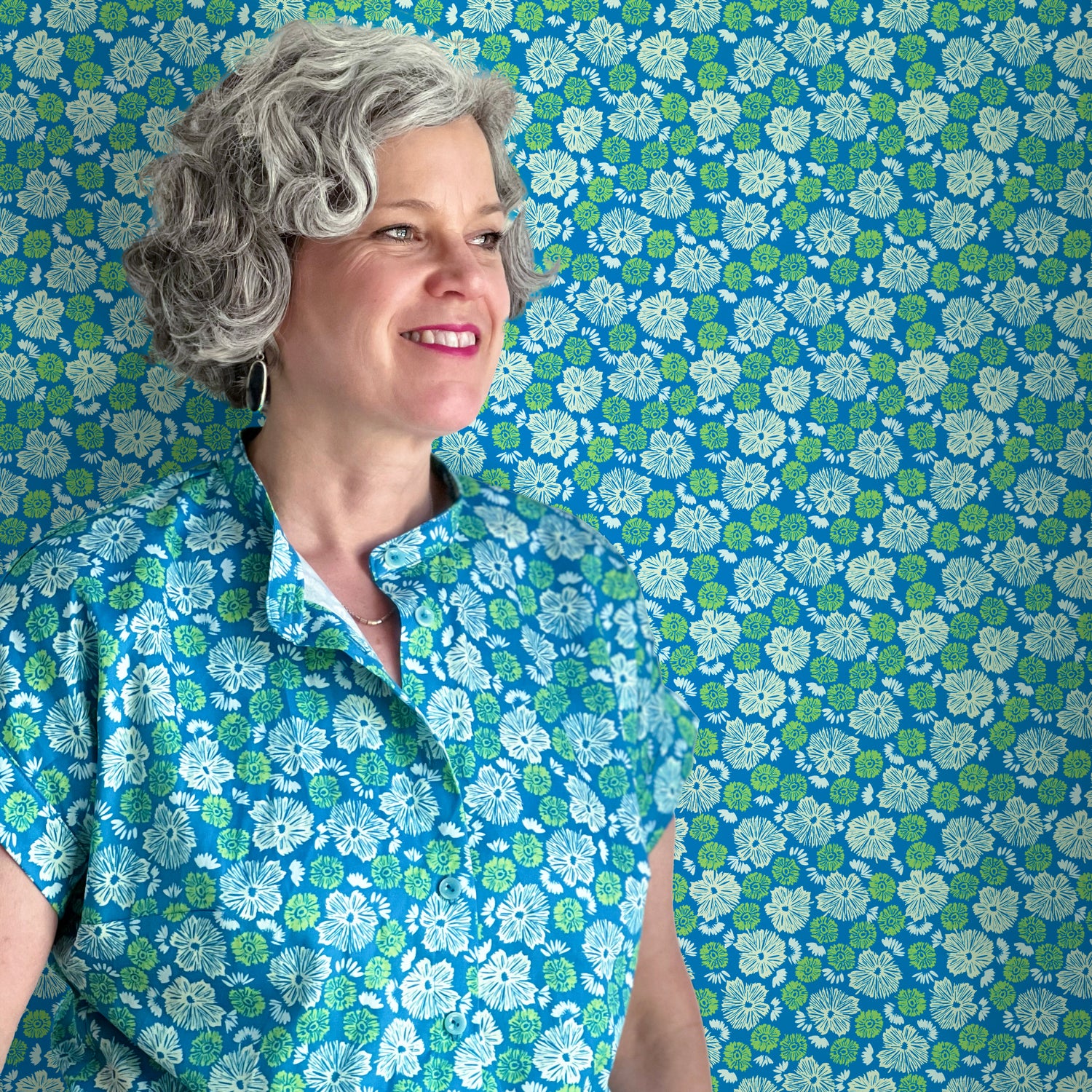 Melissa McKeagney wearing a handmade blouse in her wispy aster print in front of a background of the same print.