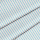 Close up of a turquoise blue ticking stripe. The fabric is folded onto itself.