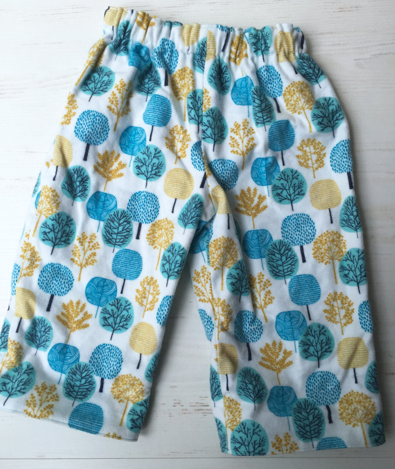 flannel reversible pants in park tree - little girl Pearl